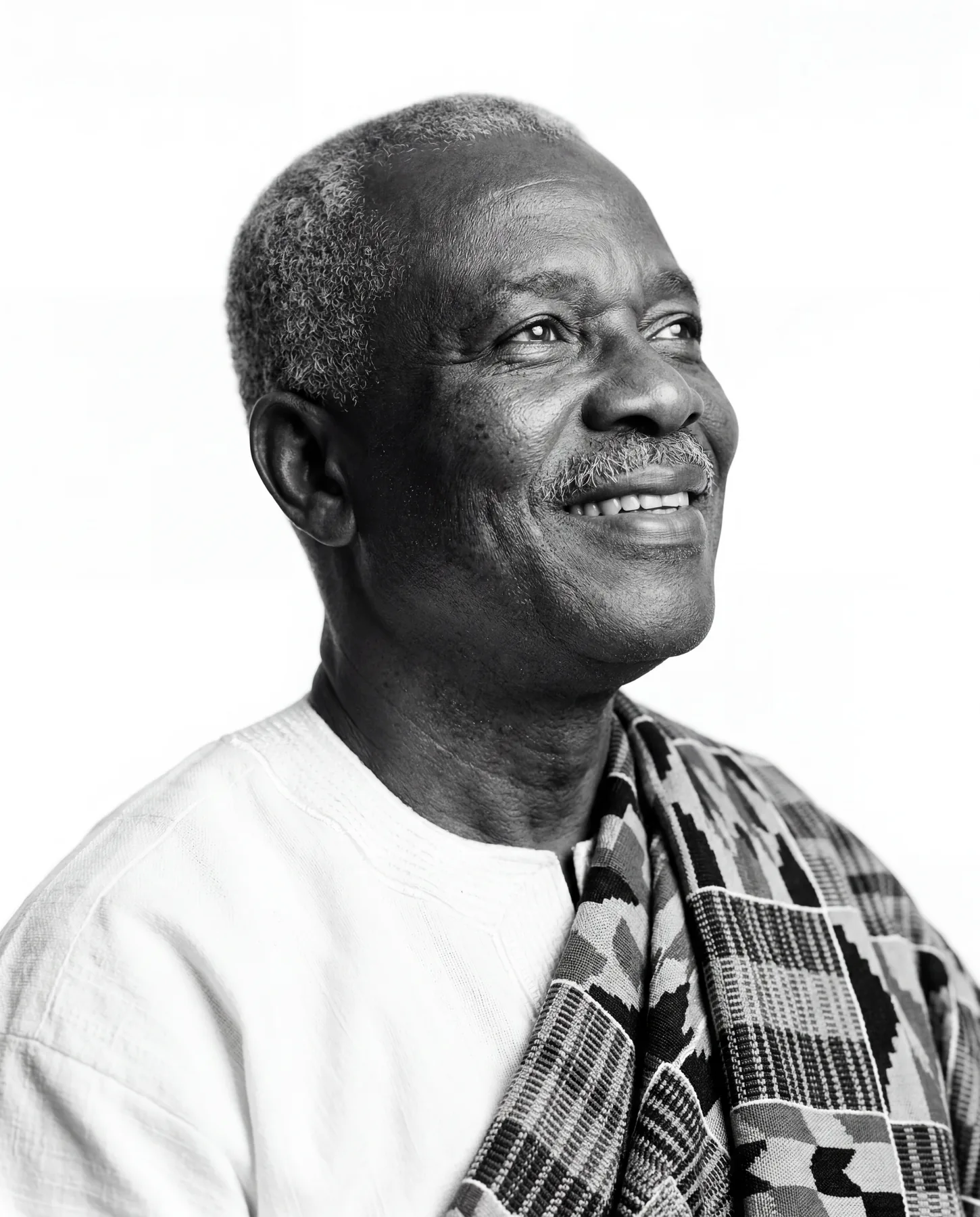 Black and white portrait of an older man in kente